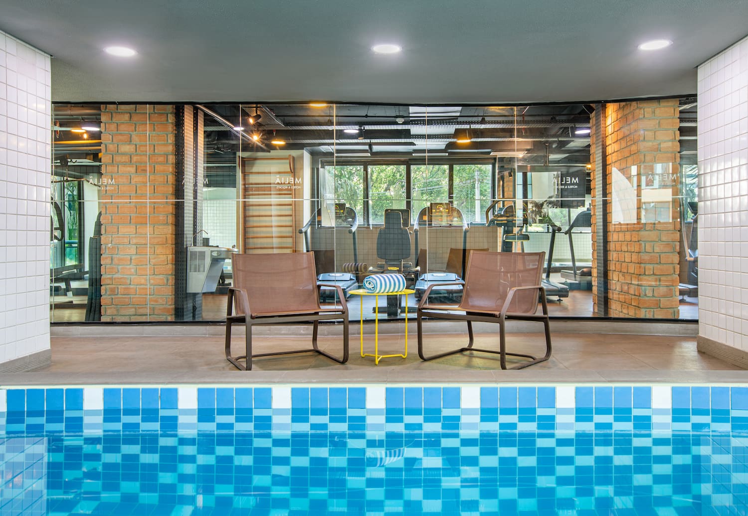 a pool with chairs and a table