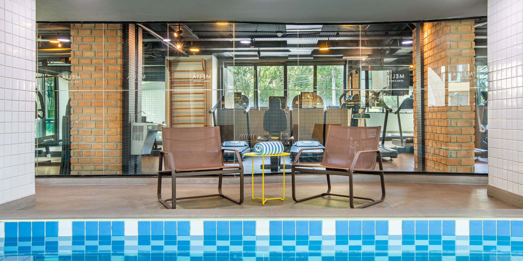 a pool with chairs and a table