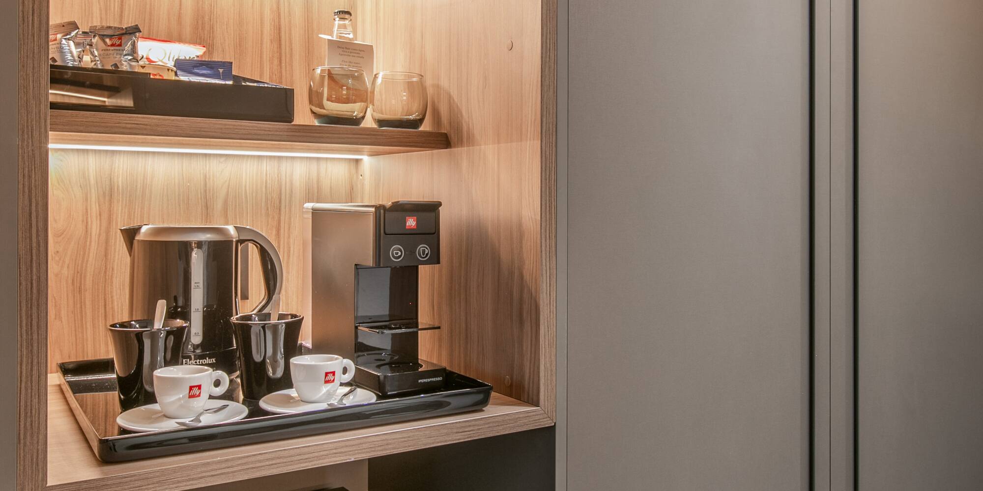 a shelf with coffee cups and a microwave
