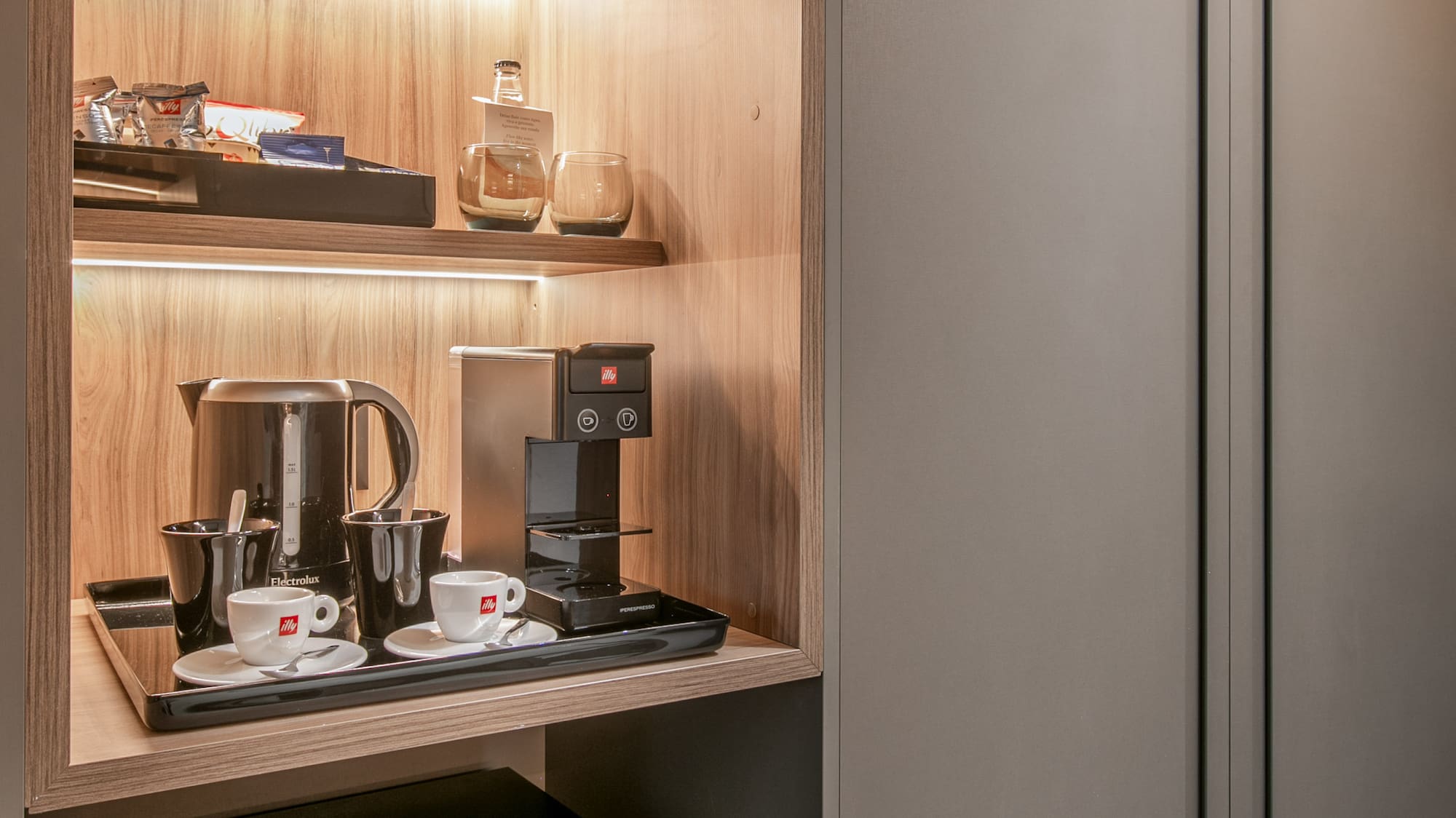 a shelf with coffee cups and a microwave