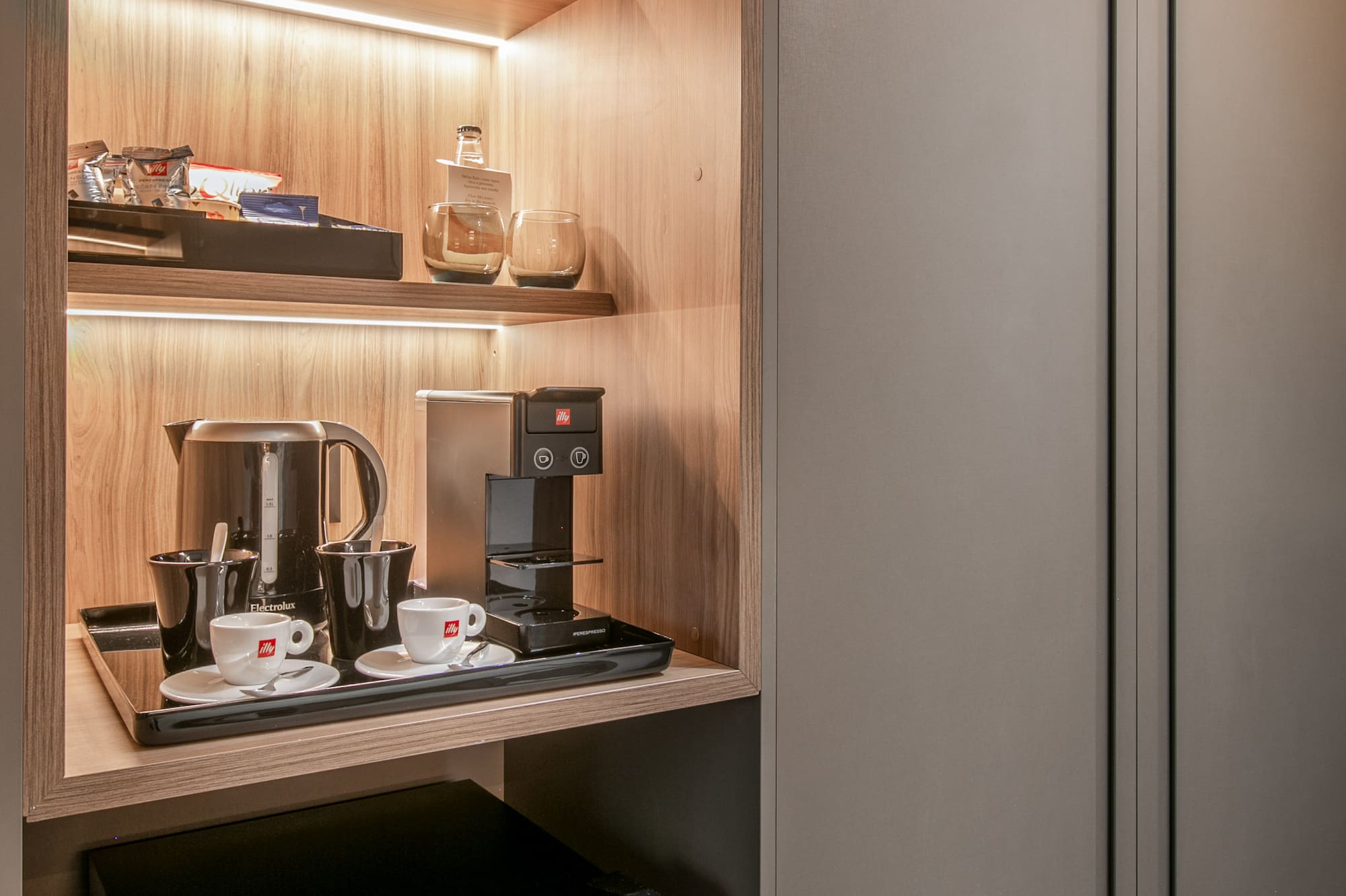 a shelf with coffee cups and a microwave