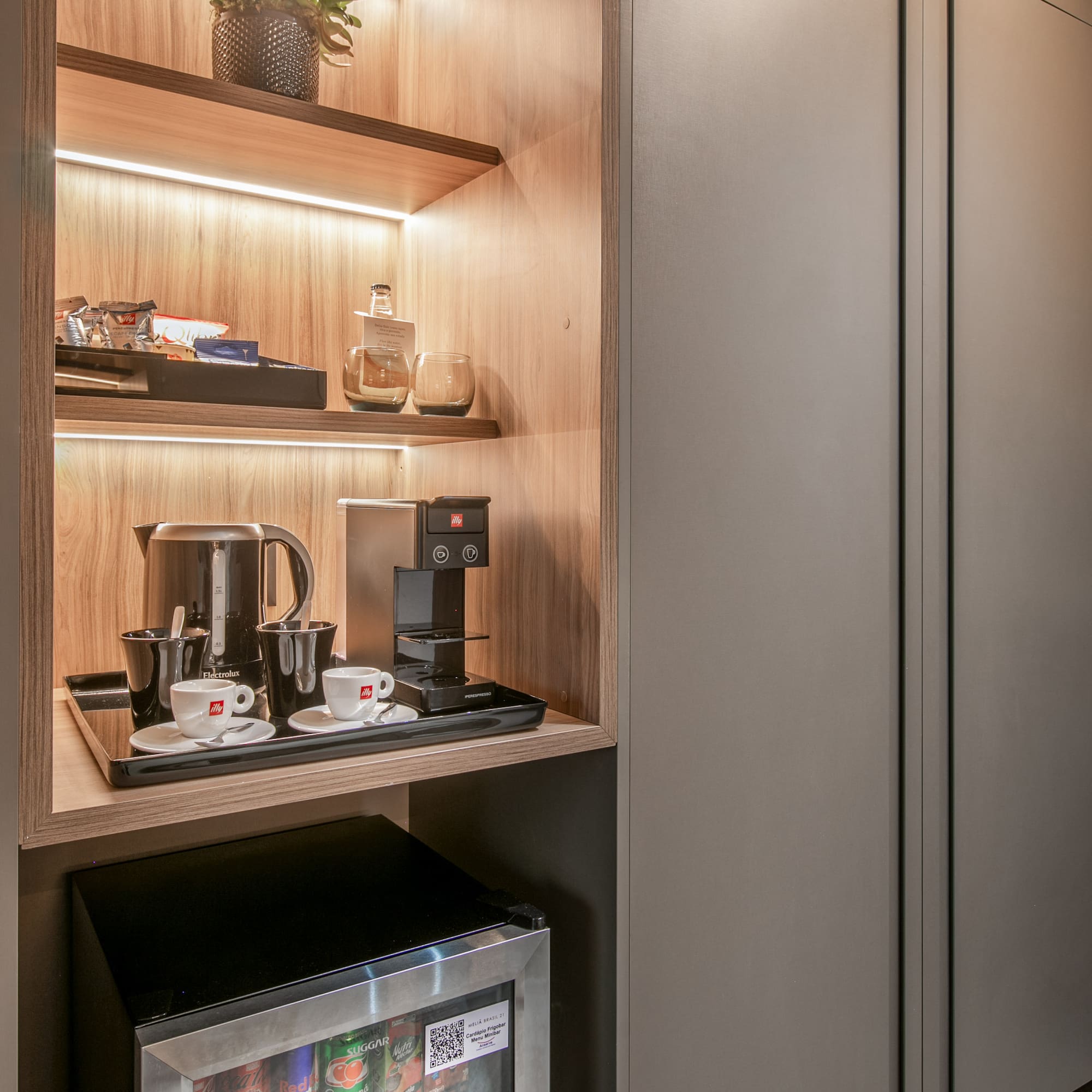 a shelf with coffee cups and a microwave