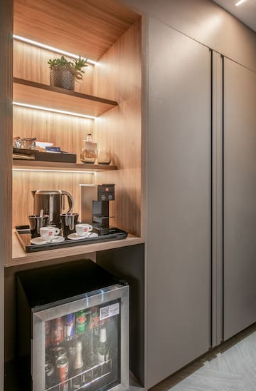 a shelf with coffee cups and a microwave