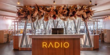 a reception desk with a sign and a large ceiling