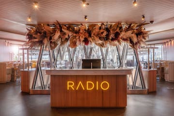 a reception desk with a sign and a large ceiling