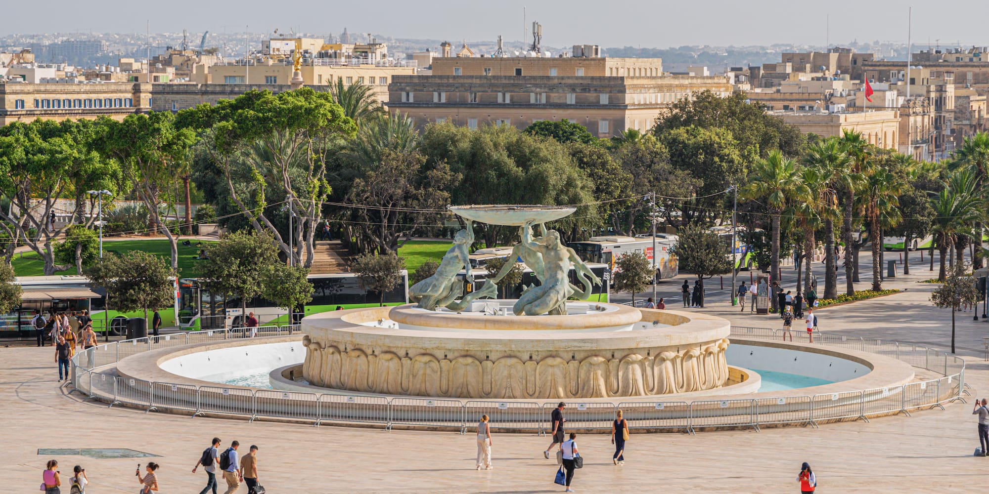 a fountain with people walking around