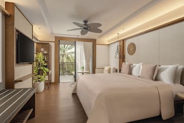 a bedroom with a television and a bed