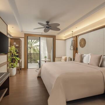 a bedroom with a television and a bed