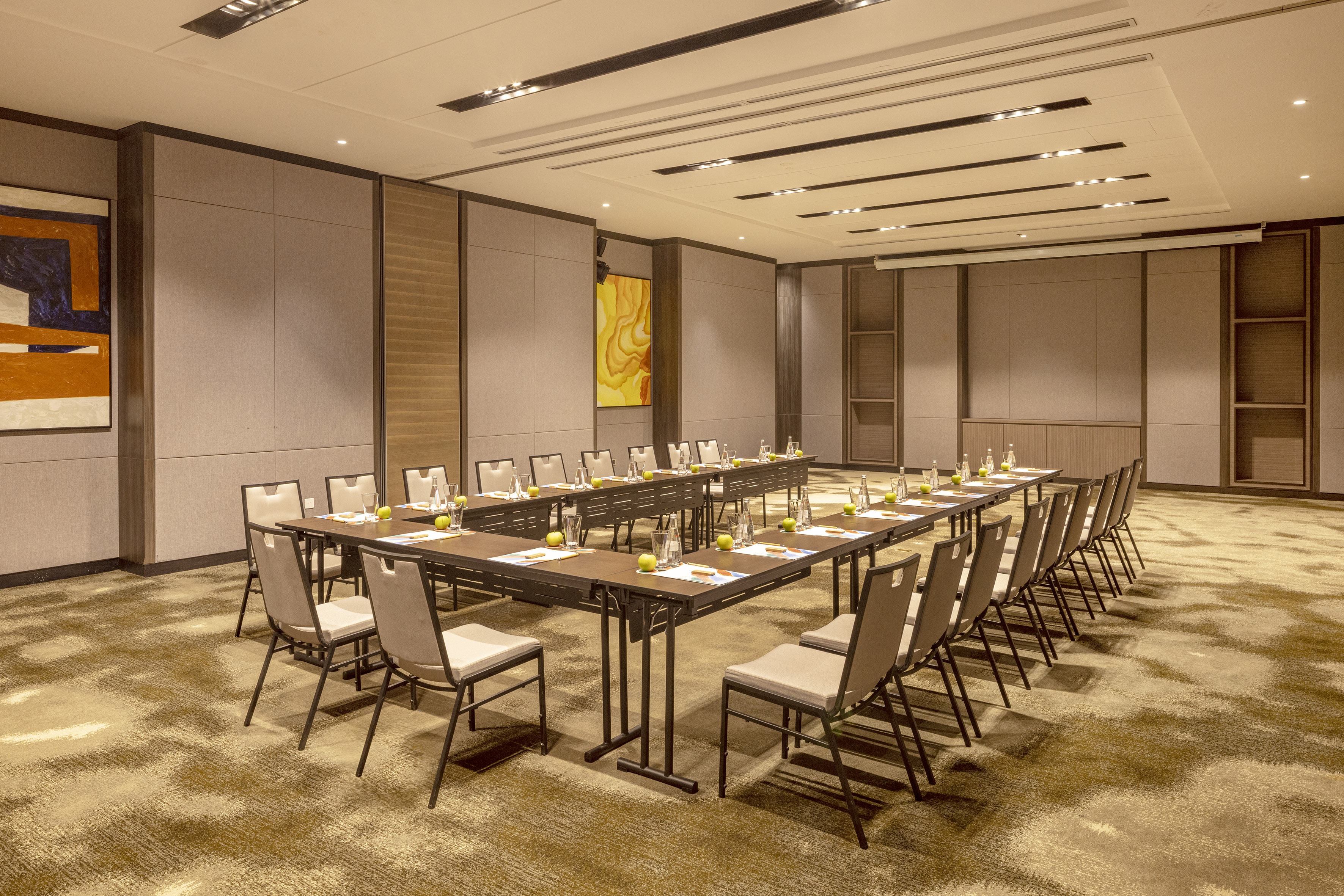 a room with a long table and chairs