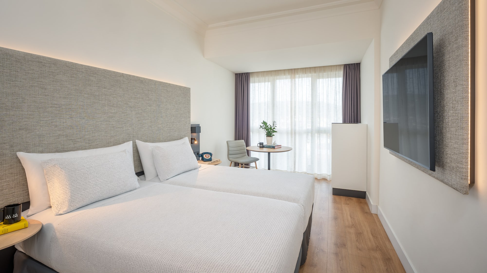 a room with two beds and a tv