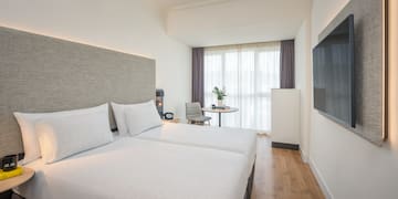 a room with two beds and a tv