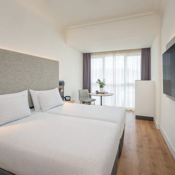 a room with two beds and a tv