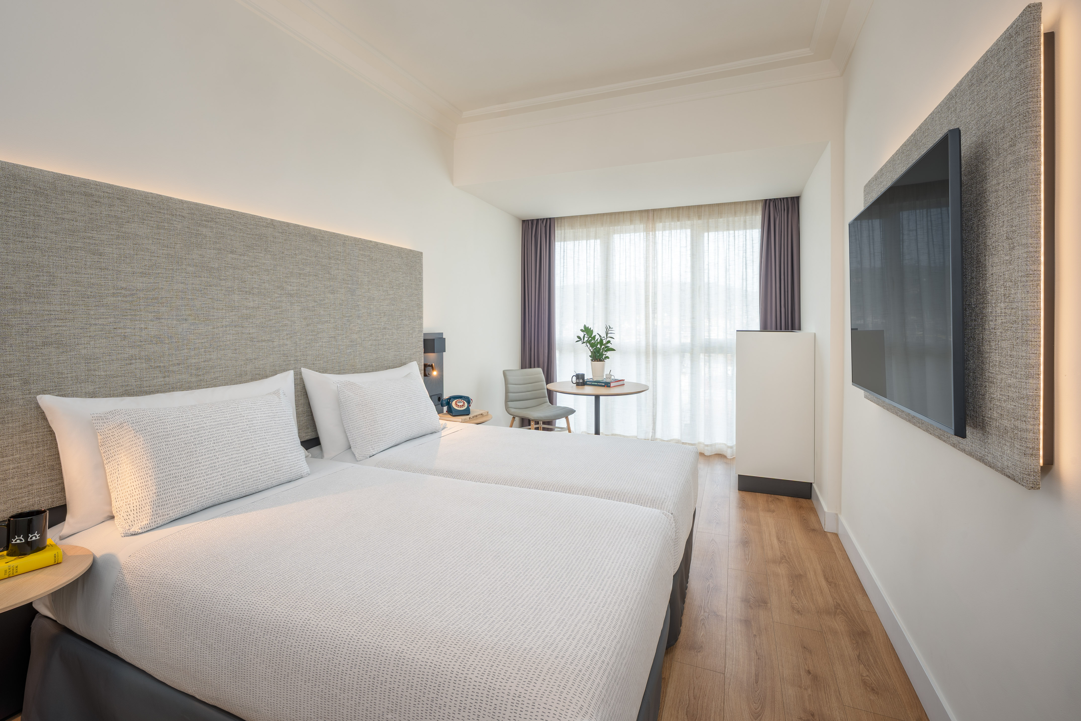 a room with two beds and a tv