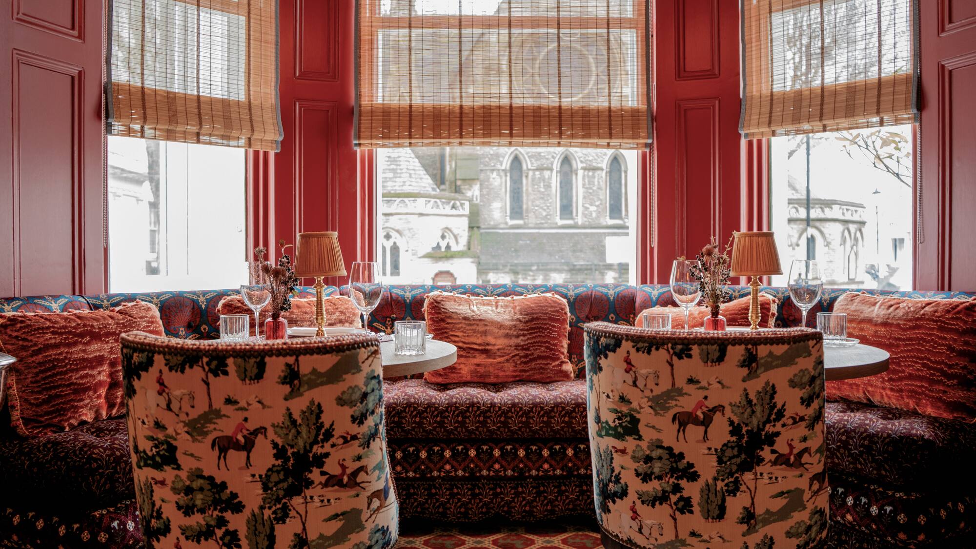 a room with a couch and tables with chairs and a couch