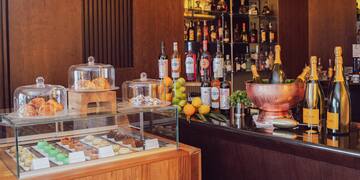 a bar with bottles of liquor and fruit on it