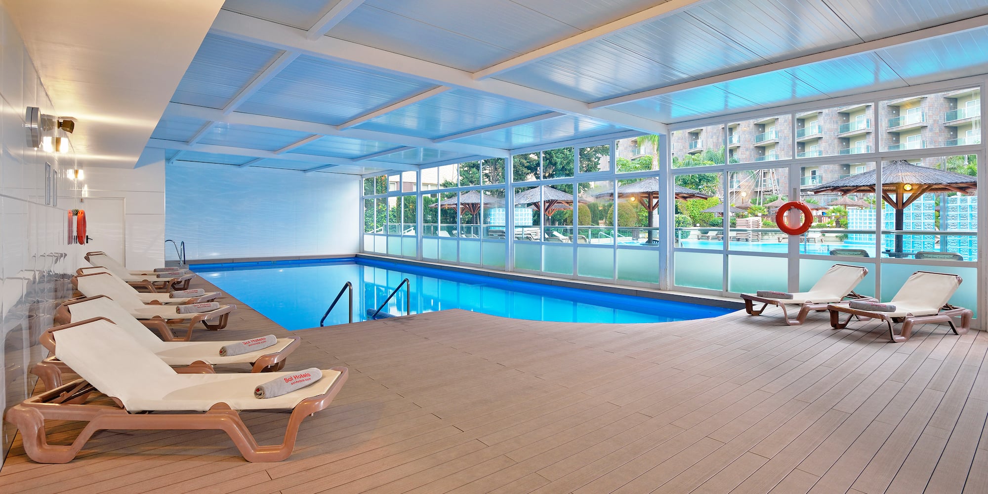 a pool with chairs and a deck chair