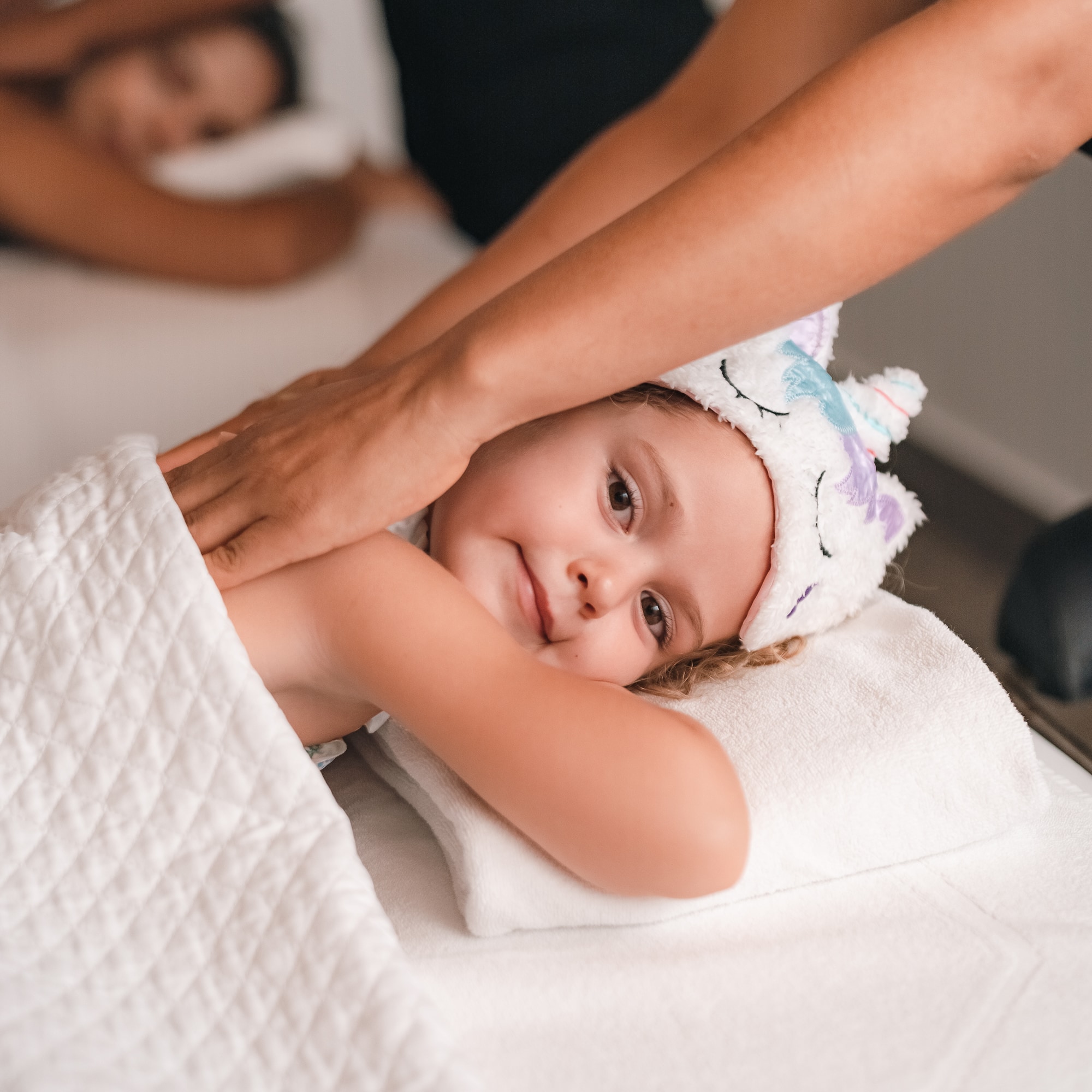 a child lying on a towel