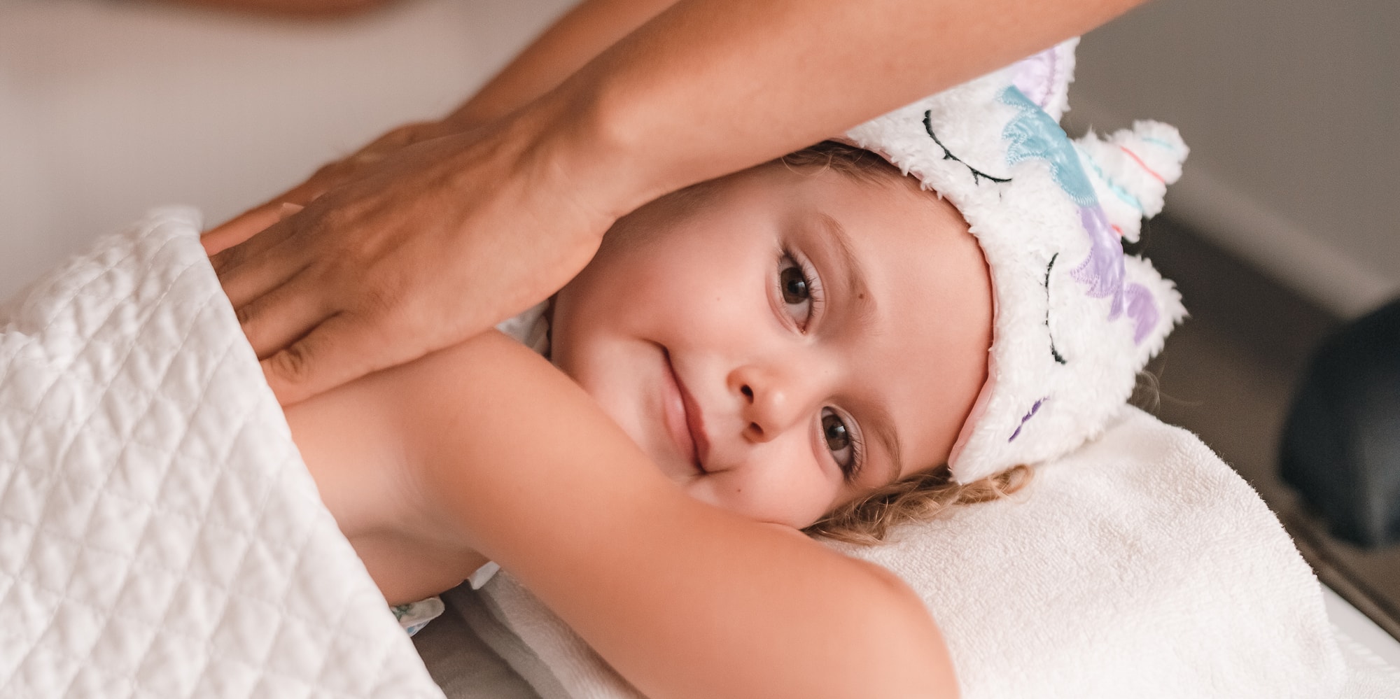 a child lying on a towel