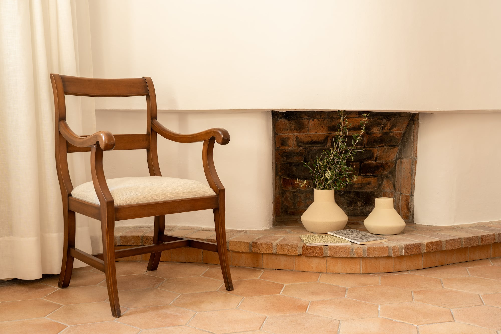 a chair next to a fireplace