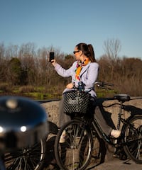 a woman on a bicycle taking a selfie