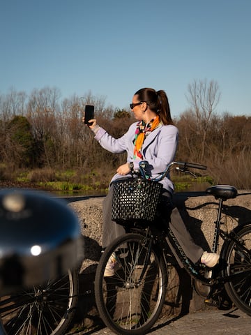a woman on a bicycle taking a selfie