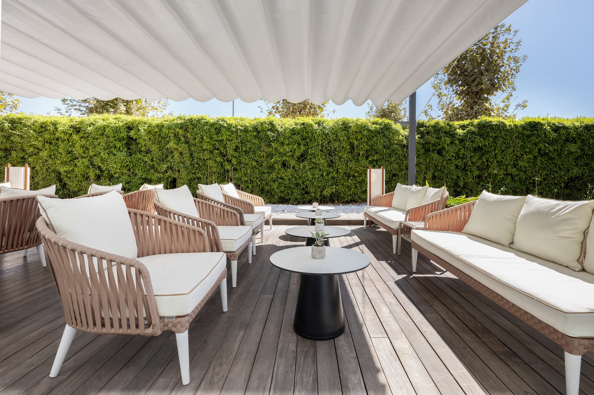 a patio with chairs and tables
