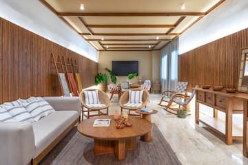 a room with a couch and chairs