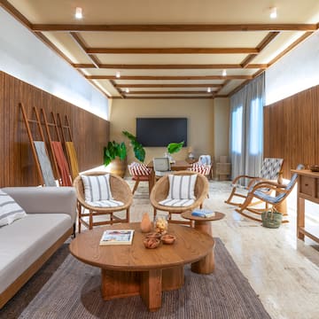 a room with a couch and chairs