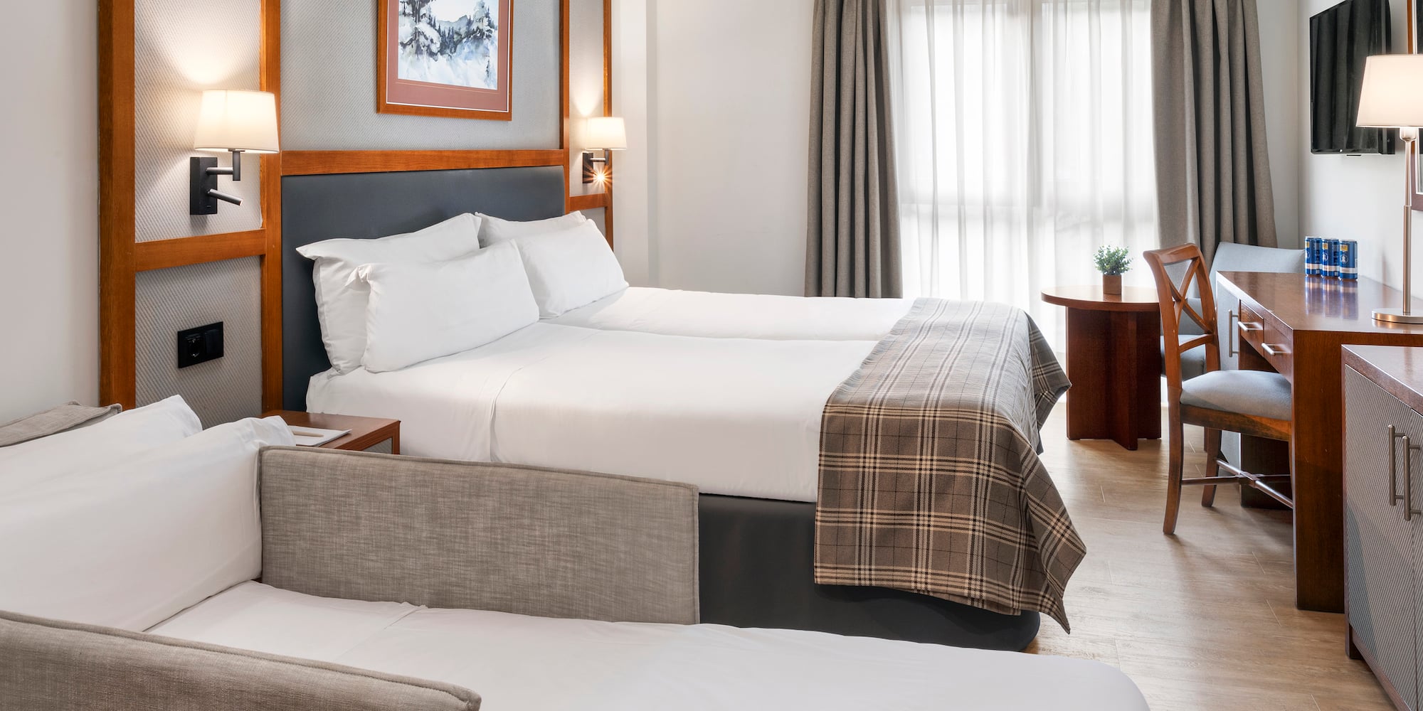 a room with two beds and a desk