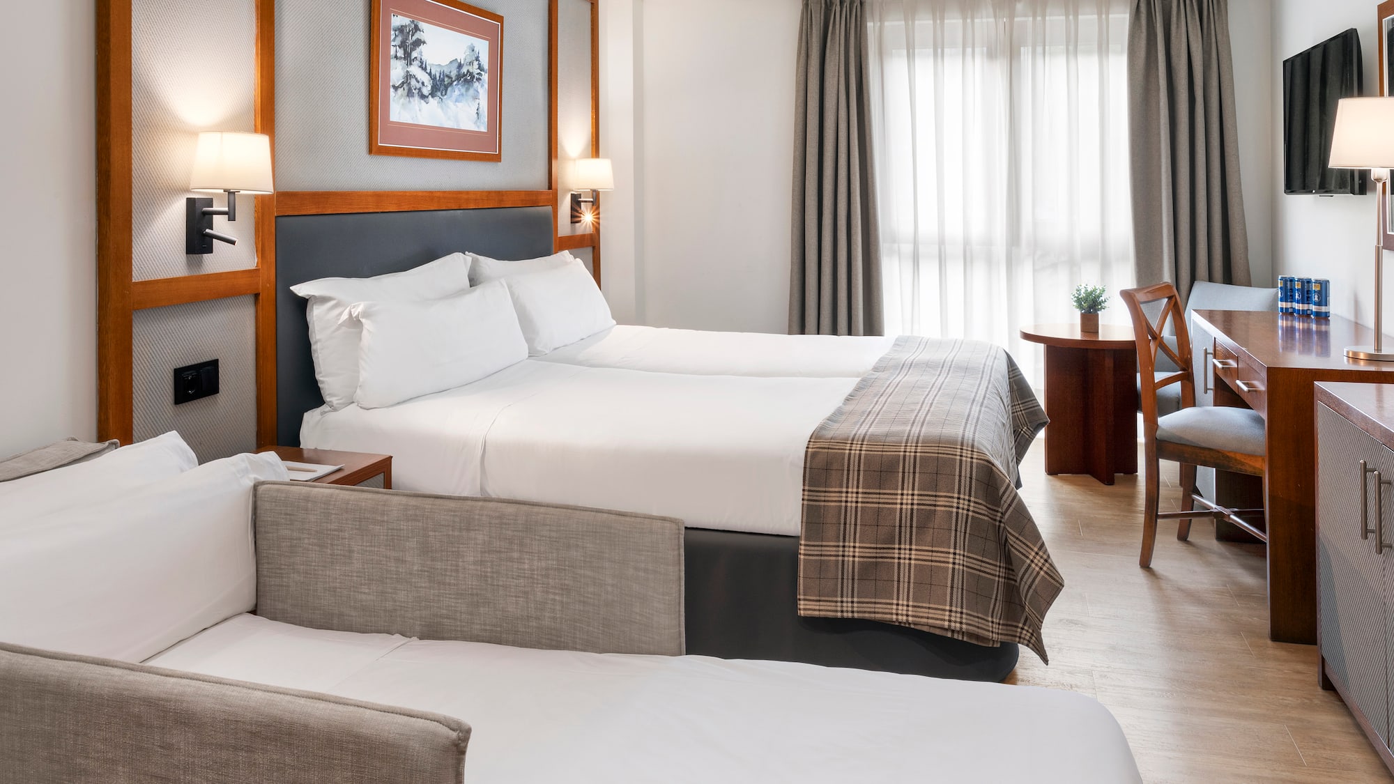 a room with two beds and a desk