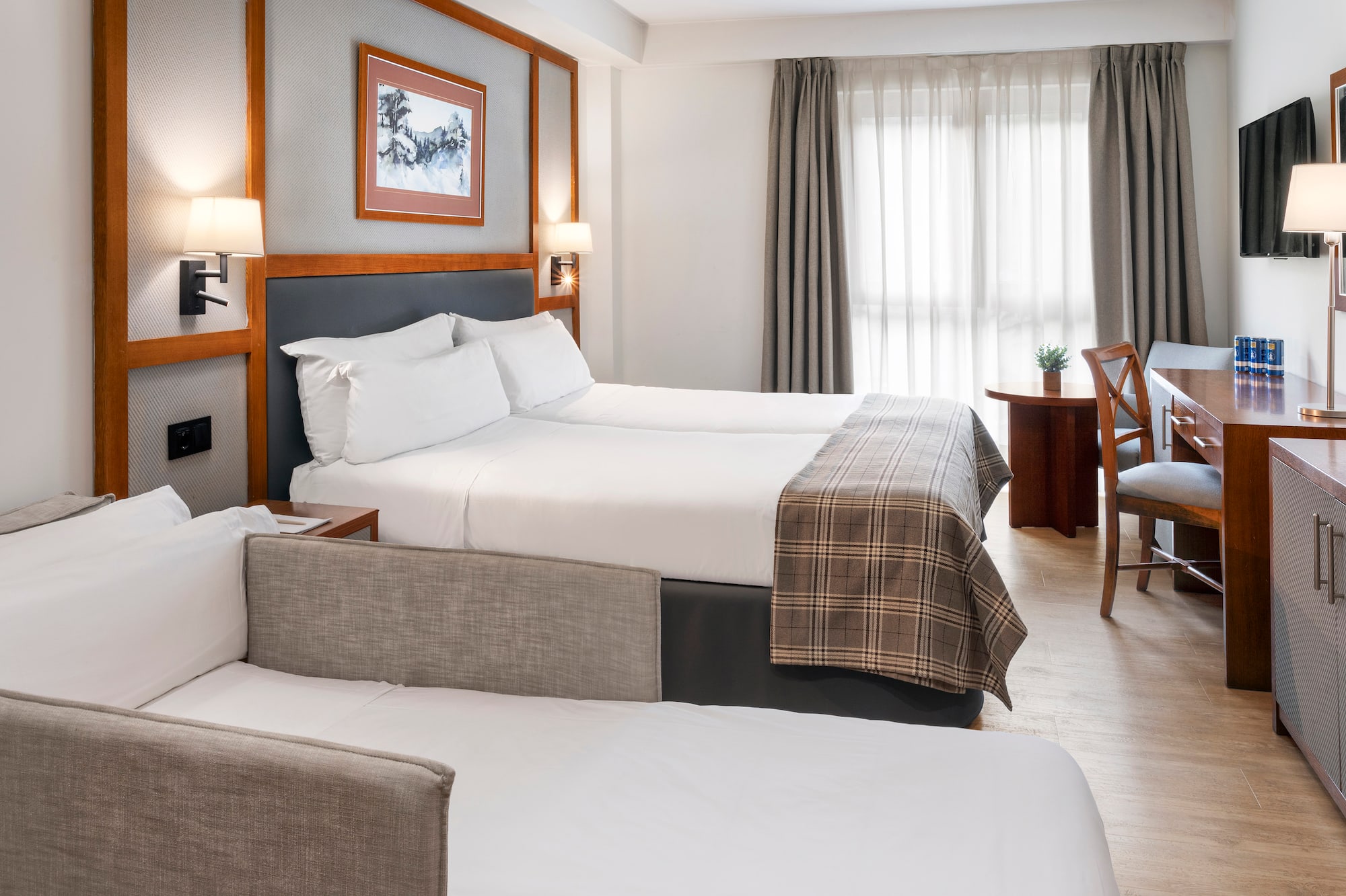 a room with two beds and a desk