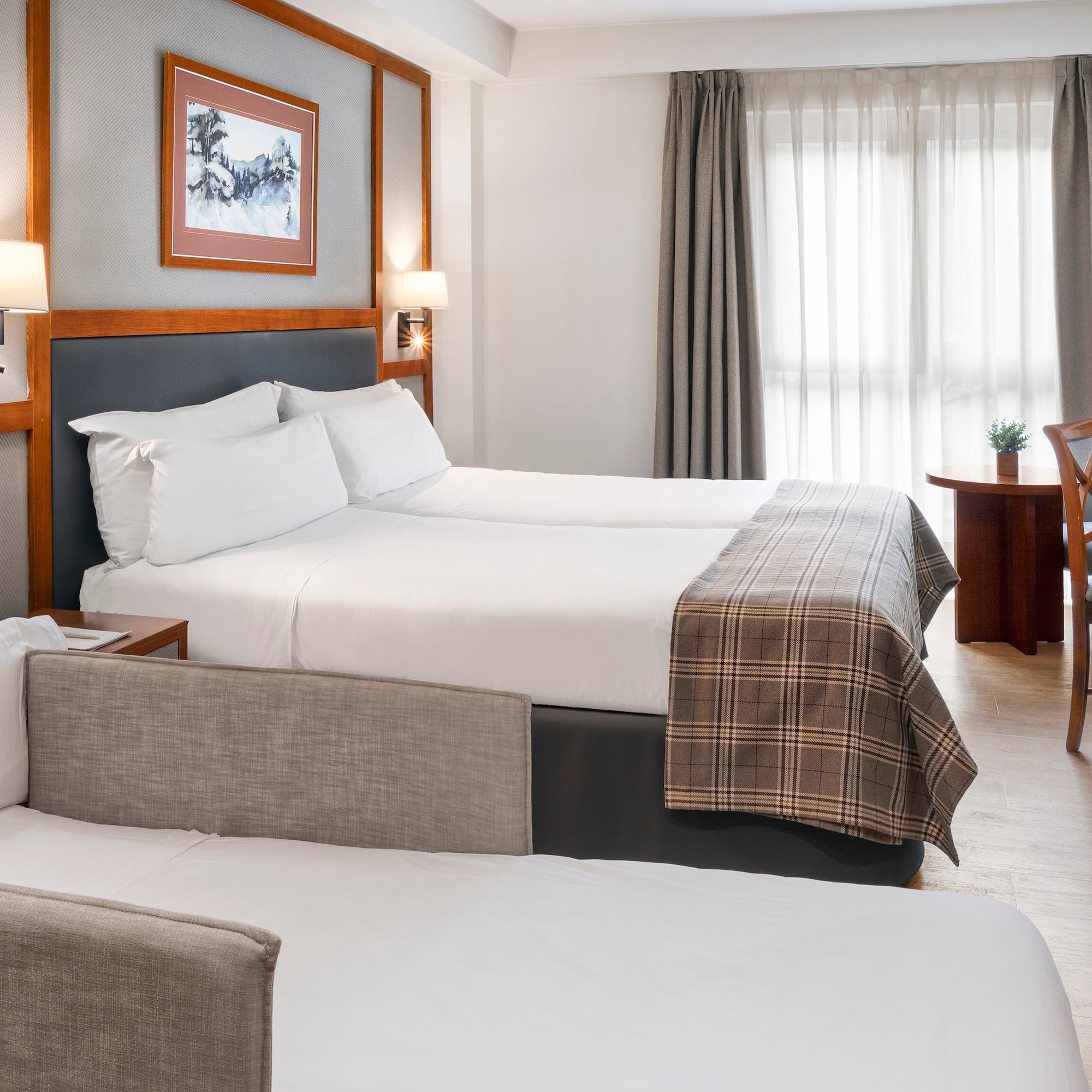 a room with two beds and a desk