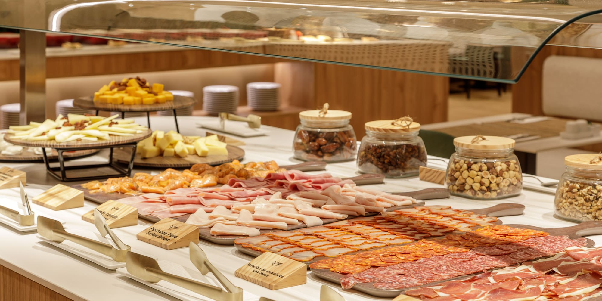 Lavish buffet with Iberian ham, charcuterie, cheeses, and various nuts.