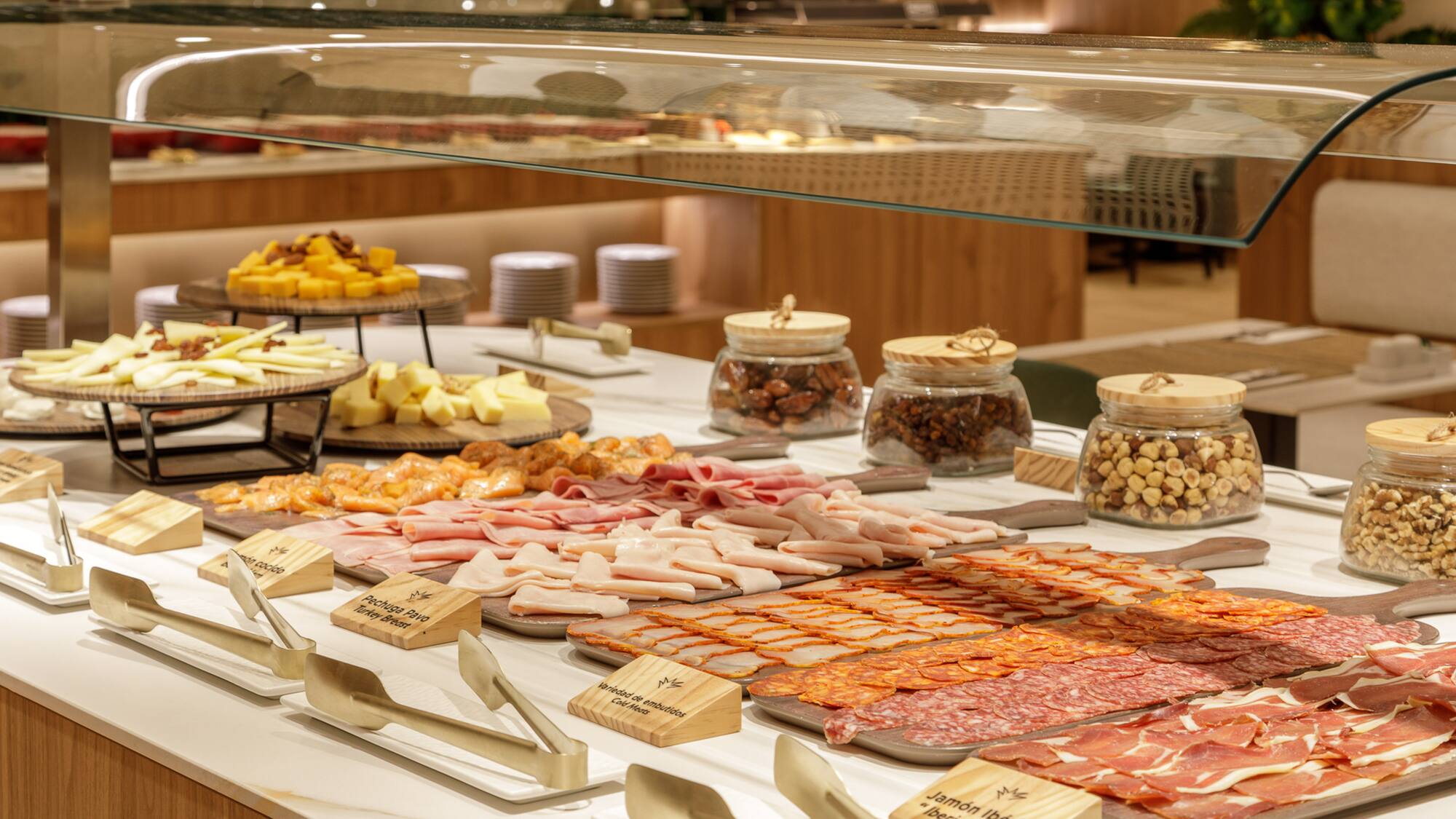 Lavish buffet with Iberian ham, charcuterie, cheeses, and various nuts.