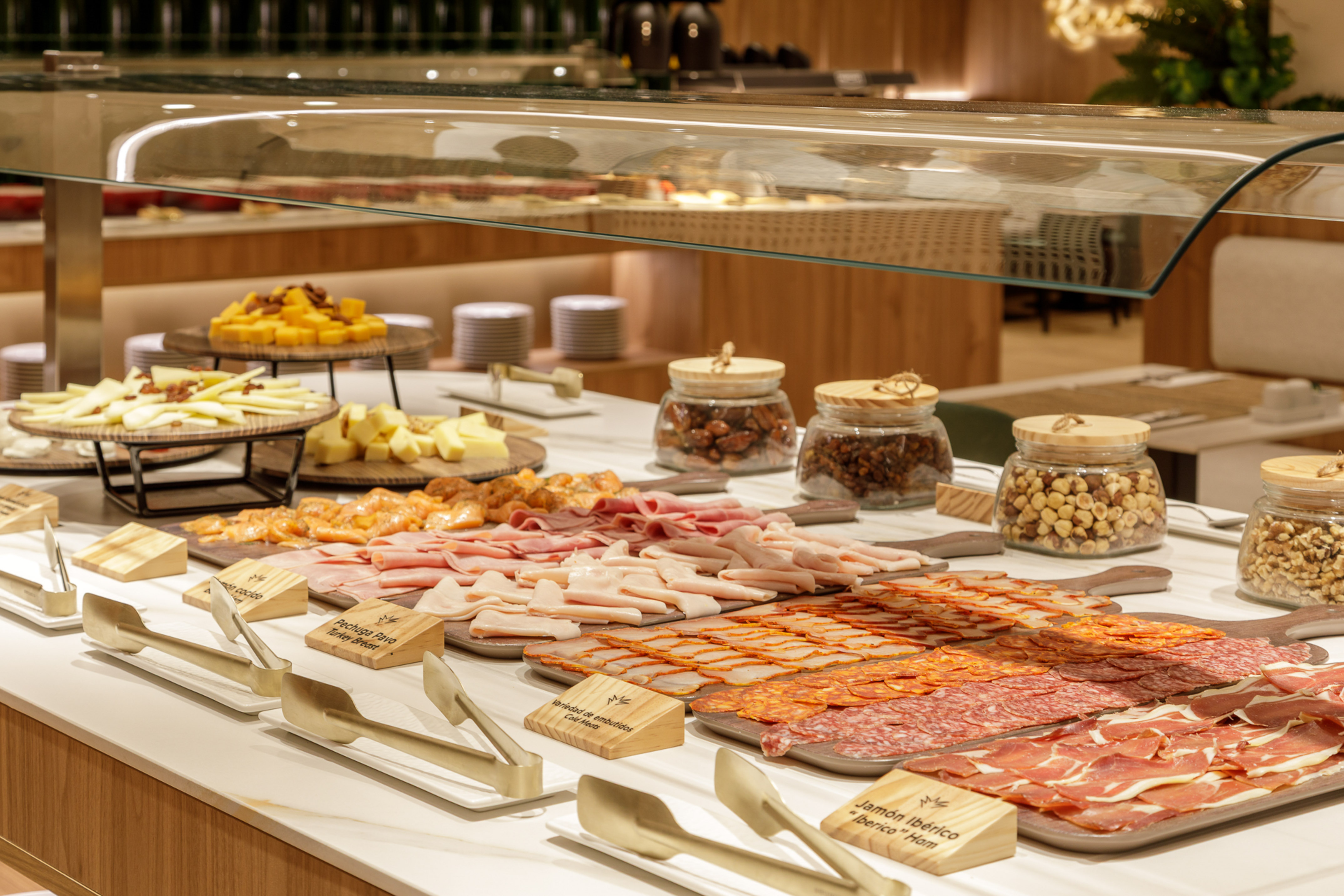 Lavish buffet with Iberian ham, charcuterie, cheeses, and various nuts.