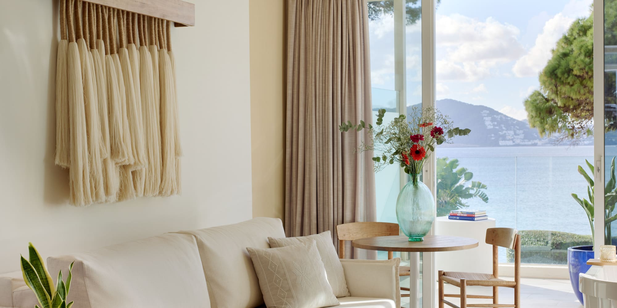 a living room with a couch and table and chairs