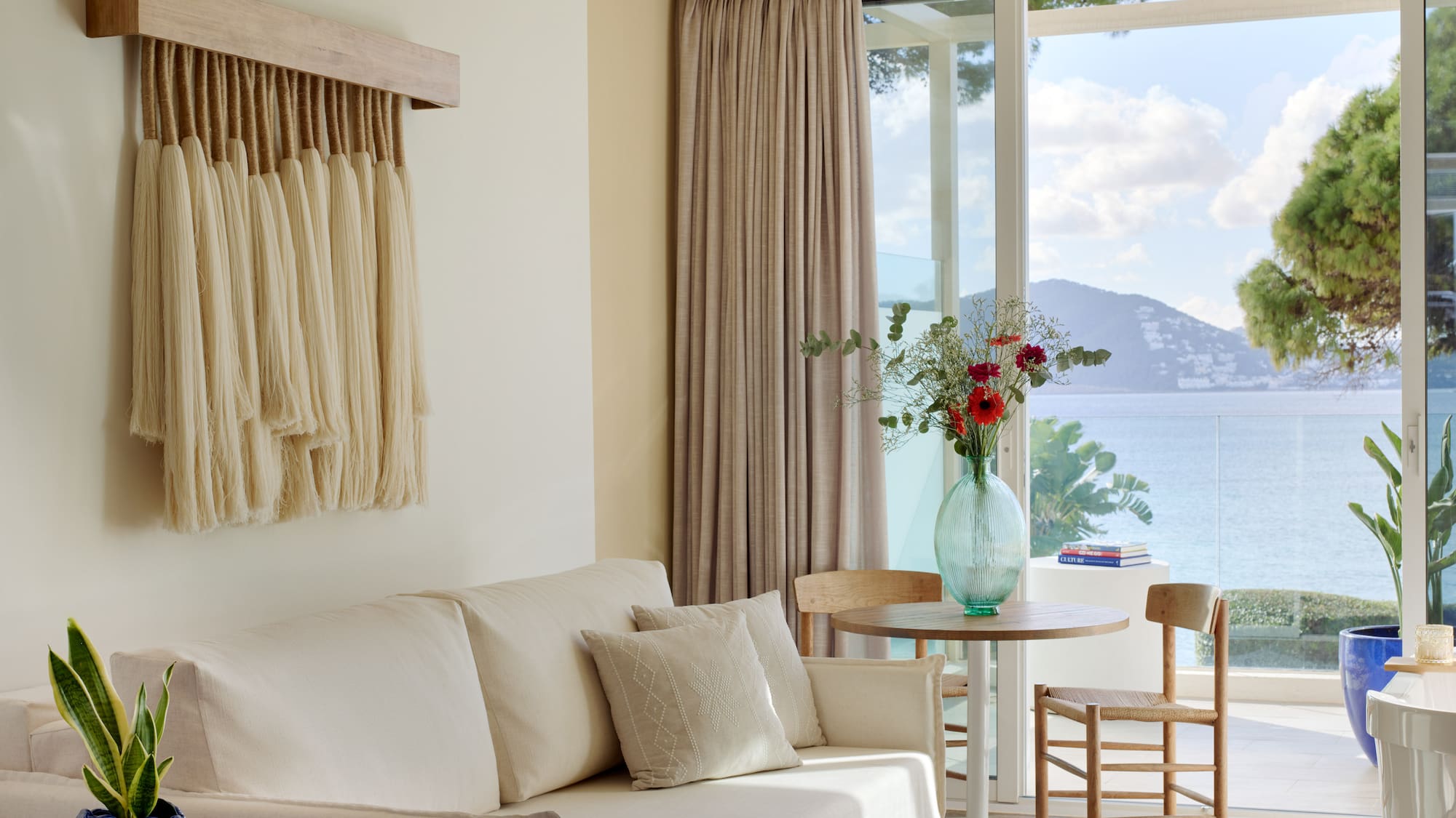 a living room with a couch and table and chairs