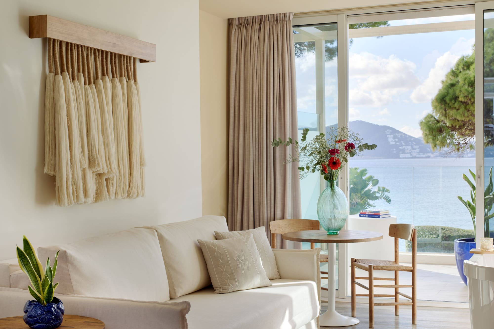 a living room with a couch and table and chairs