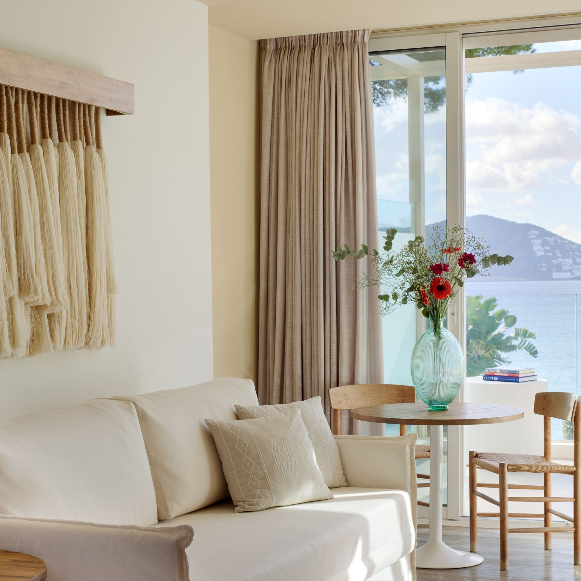a living room with a couch and table and chairs
