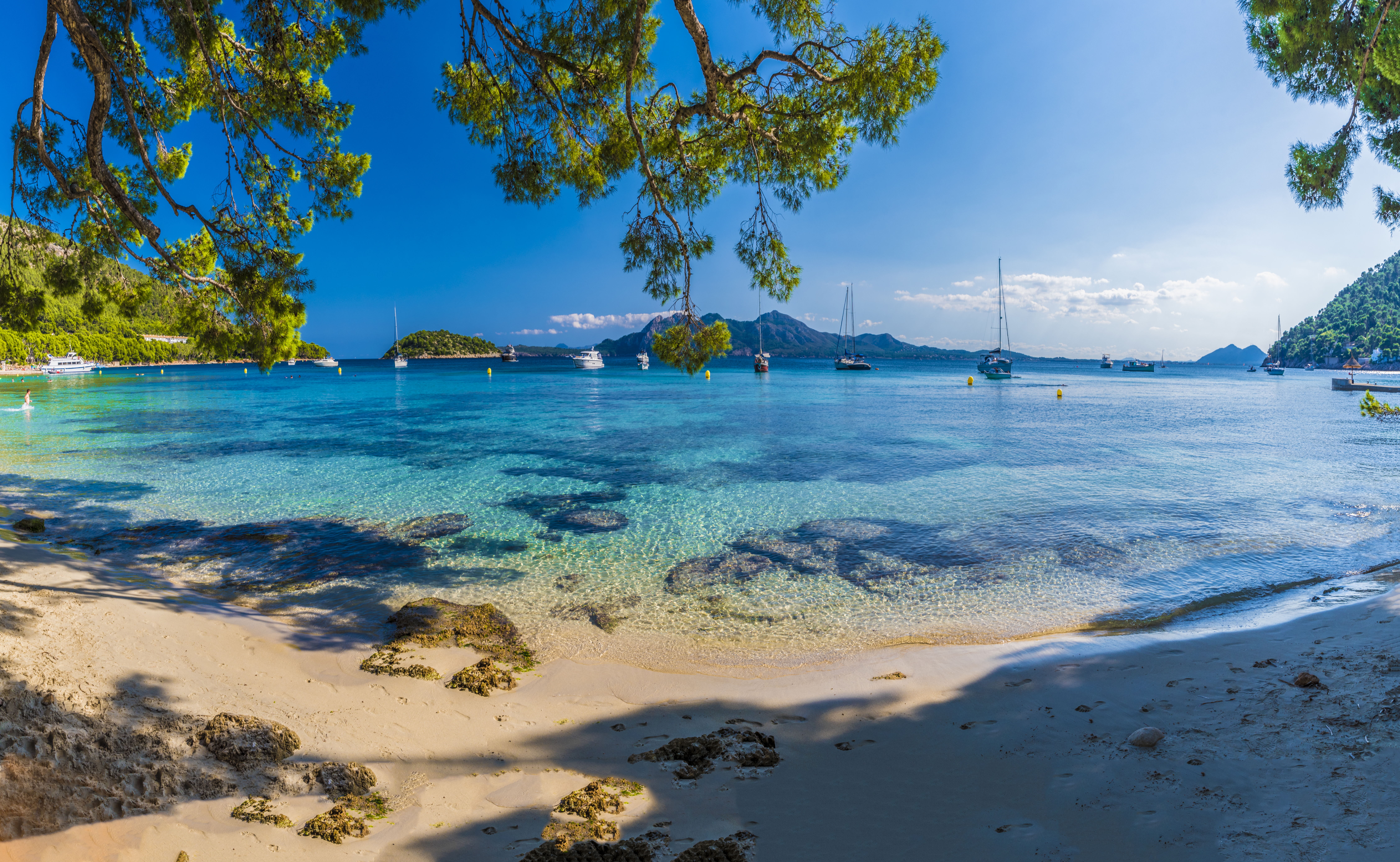 a beach with boats in the water