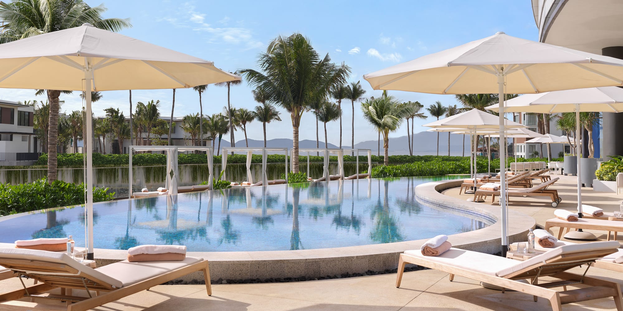 a pool with lounge chairs and umbrellas