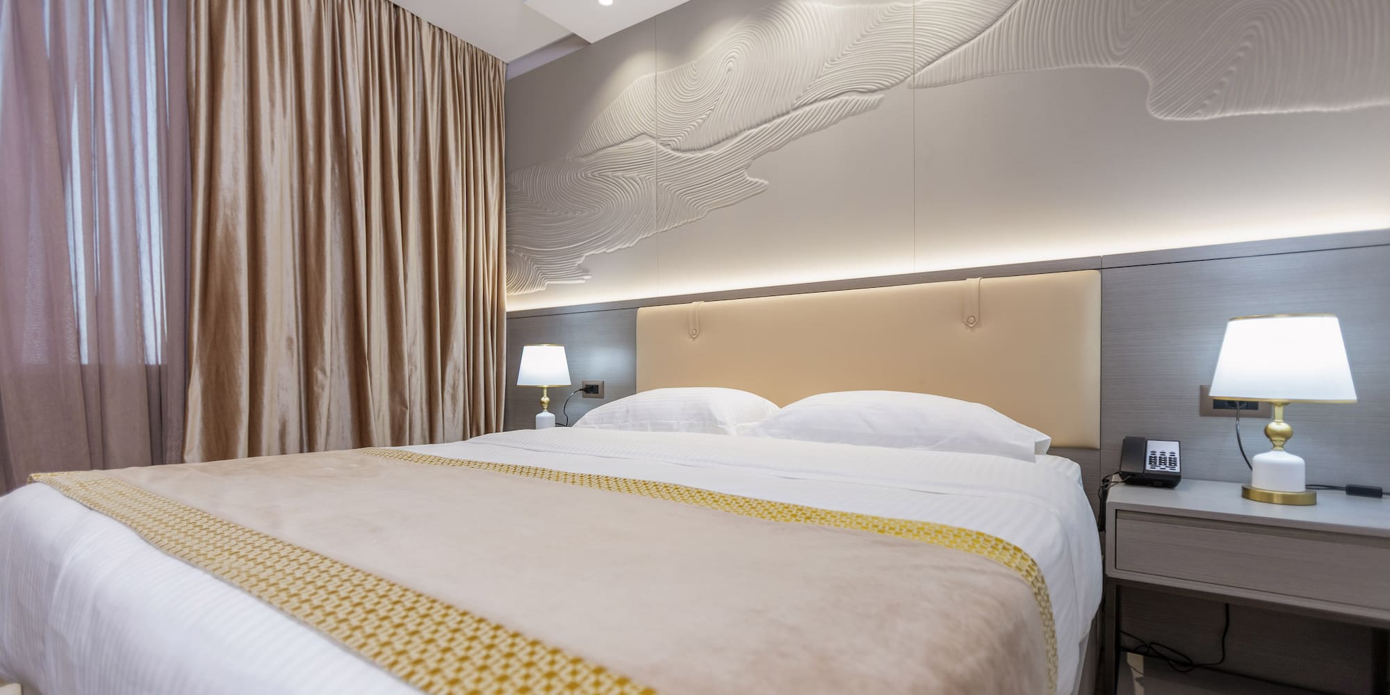 a bed with a lamp and a table