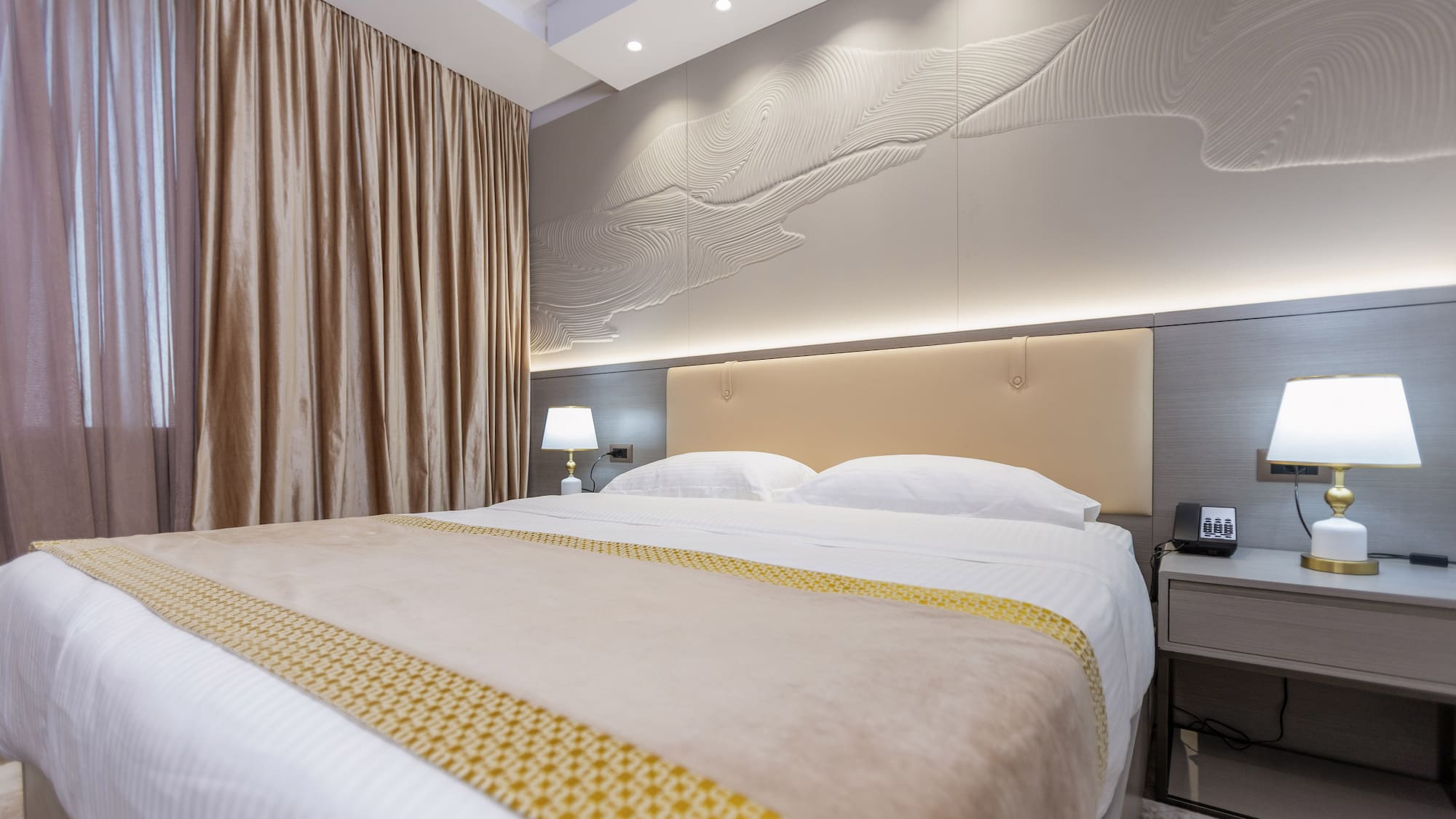 a bed with a lamp and a table