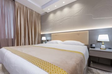 a bed with a lamp and a table