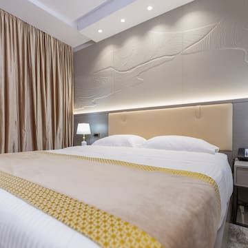 a bed with a lamp and a table