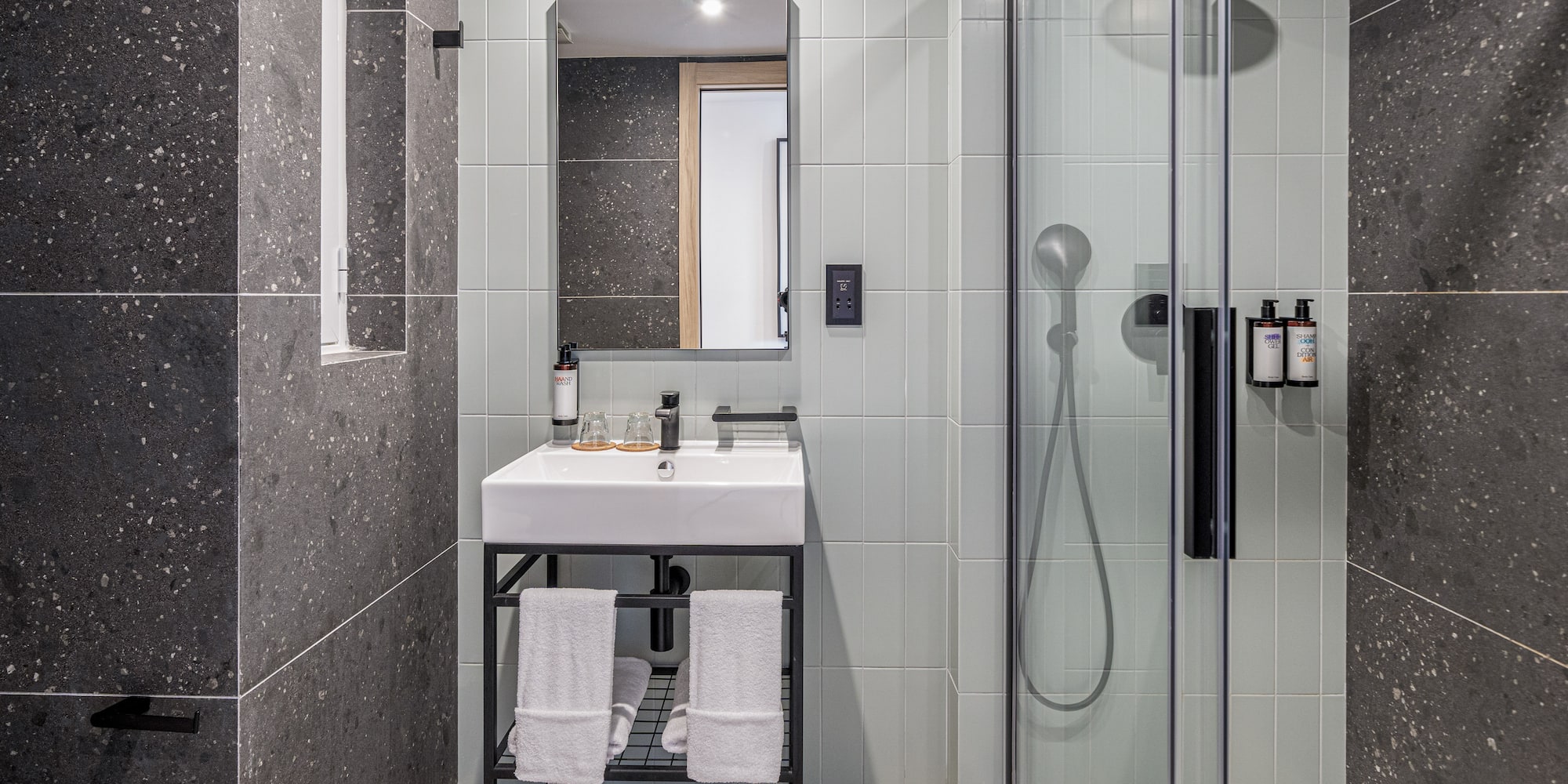 a bathroom with a shower and sink