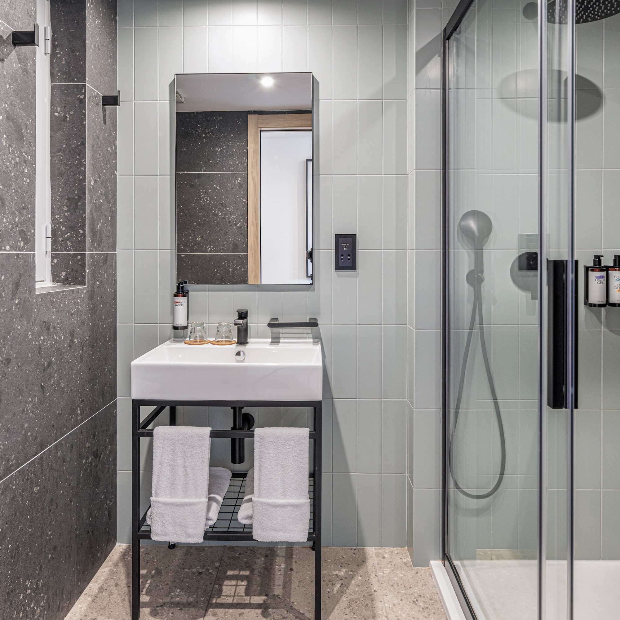 a bathroom with a shower and sink