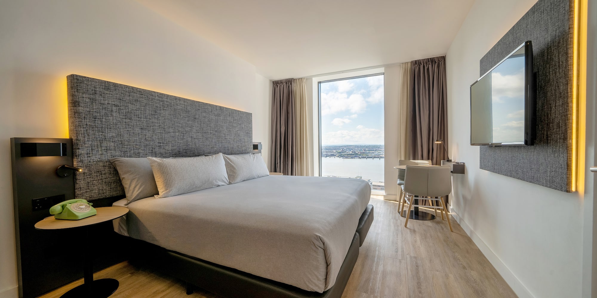 a room with a bed and a television