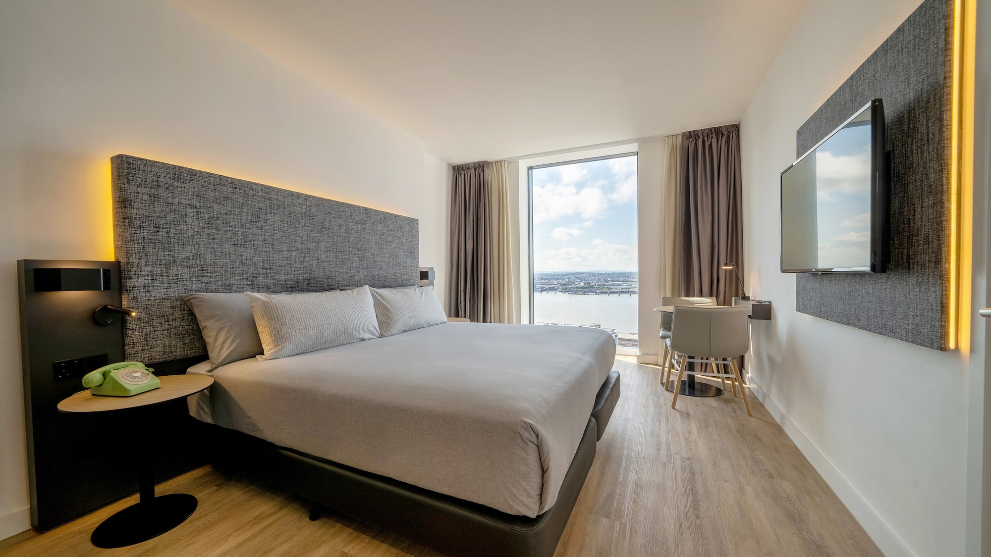 a room with a bed and a television