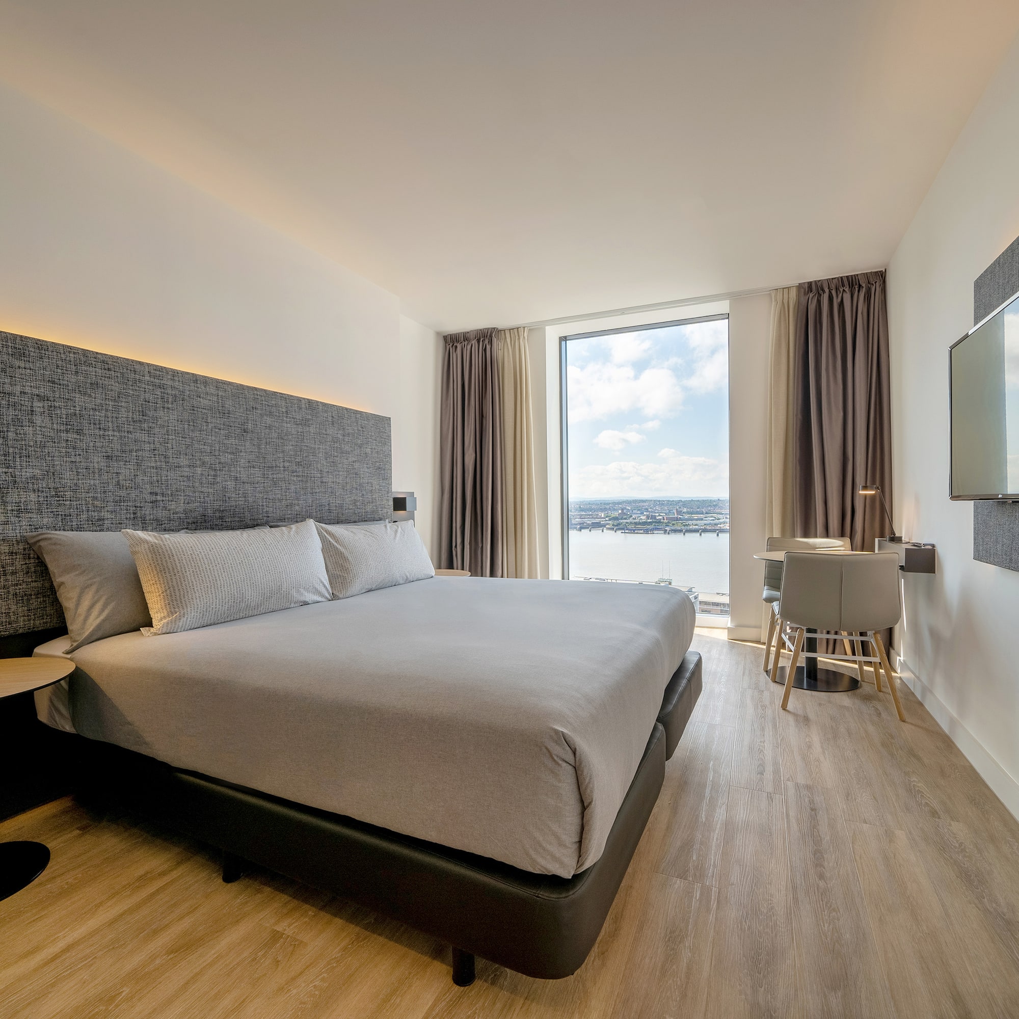 a room with a bed and a television